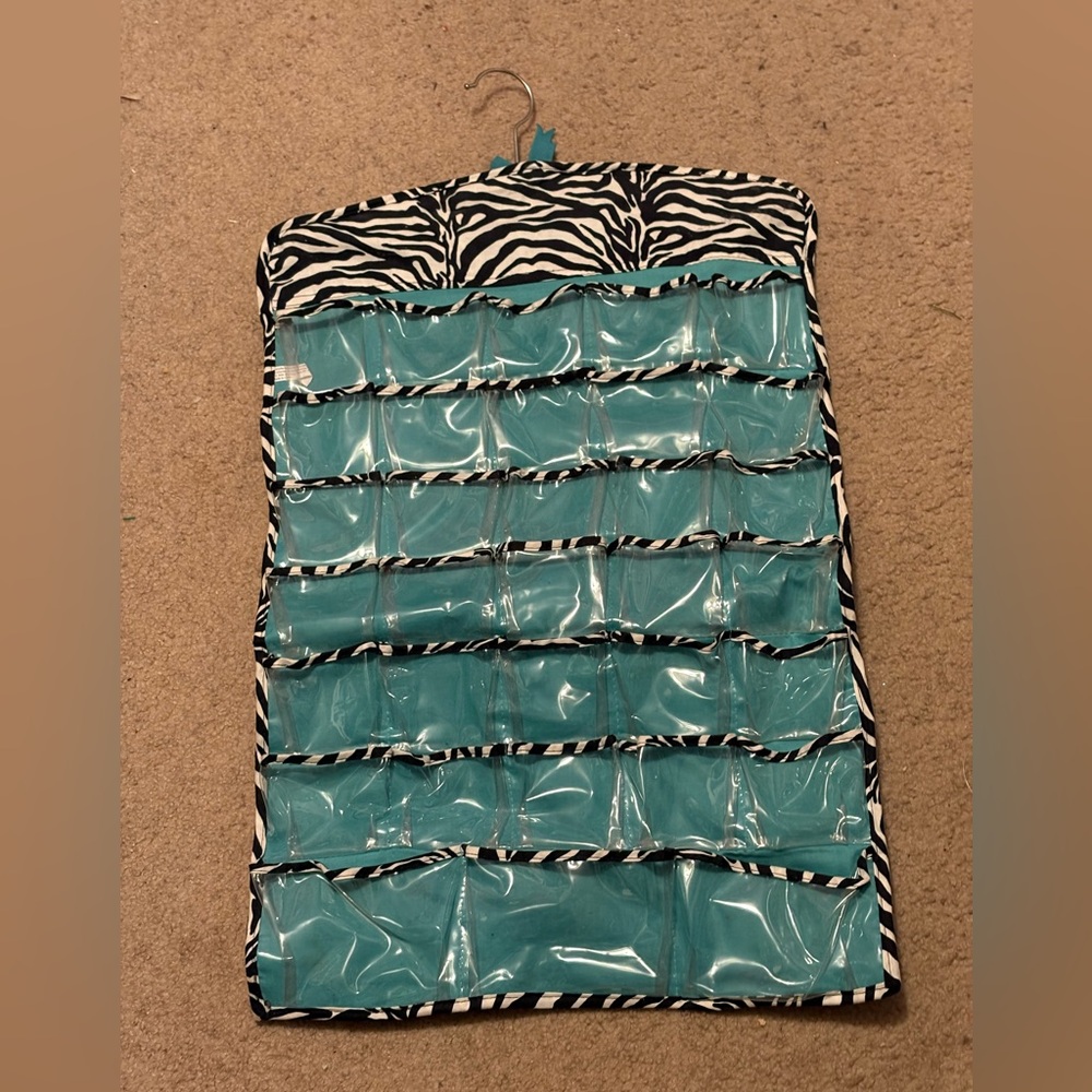 NWOT blue and zebra print 66 compartment hanging jewelry rack